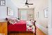 Bedroom with ceiling fan and hardwood / wood-style floors