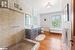 Full bathroom with vanity, separate shower and tub, wood-type flooring, and toilet