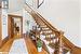 Stairway featuring wood-type flooring and a high ceiling