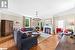 Living room with crown molding, a chandelier, and light hardwood / wood-style floors