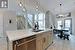 Custom kitchen with quartz countertops, high end appliances including gas stove