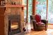 Stone fireplace with wood mantle.