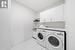 Large laundry room with sink & storage.