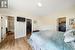 Bedroom featuring a closet, a walk in closet, hardwood / wood-style flooring, and ensuite bath