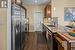 Stainless appliances with walk-in pantry.