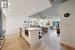 Kitchen featuring an island with sink, ceiling fan, light hardwood / wood-style floors, appliances with stainless steel finishes, and sink