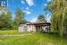 Left side of property featuring the house and storage shed.