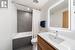 Full bathroom featuring vanity, tile walls, shower / tub combo, toilet, and tile patterned flooring