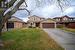 View of front of home featuring a garage and a front lawn