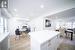 Kitchen with white cabinets, light hardwood / wood-style flooring, and a center island