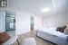 Bedroom with a closet, a spacious closet, a barn door, and light wood-type flooring