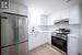 Kitchen featuring stainless steel appliances, sink, tasteful backsplash, light hardwood / wood-style flooring, and white cabinets