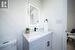 Bathroom with vanity, hardwood / wood-style flooring, and toilet