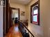 Upper level apartment with original staircase, stained glass window, pine plank floors, original trim and high ceilings.