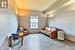 Living area featuring a baseboard radiator and wood-type flooring