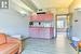 Kitchen with a baseboard heating unit, sink, and light hardwood / wood-style flooring