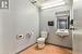 Bathroom with a paneled ceiling, sink, and toilet