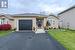 Bungalow house with a front yard and a garage