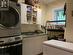 Modern fully finished laundry room with plenty of storage and double sinks.