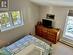 Sunken master bedroom with vaulted ceiling.