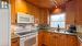 Open concept kitchen/dining/living room with picture windows and gas fireplace overlooking the lake.