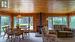 Open concept kitchen/dining/living room with picture windows and gas fireplace overlooking the lake.