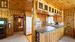 Open concept kitchen/dining/living room with picture windows and gas fireplace overlooking the lake.