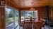 Open concept kitchen/dining/living room with picture windows and gas fireplace overlooking the lake.