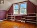 Primary bedroom with built-in shelves and beautiful hardwood floors