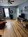 Living room with a wealth of natural light, ceiling fan, a textured ceiling, and light hardwood / wood-style flooring