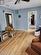 Living room with light wood-type flooring, a textured ceiling, and ceiling fan