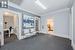 Living area with crown molding and dark carpet