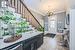 Tiled foyer with a notable chandelier and ornamental molding