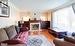 Living room with hardwood floors, gas fireplace and big bright window.