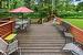 MORE outdoor living space.  Large deck , private setting with creek bordering and all treed.