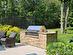 A granite topped built-in Viking Gas BBQ is the ideal place to cook for a large crowd. The gas line is inground. The fenced area beyond can be used as a batting cage, golf swing practice area or w