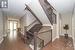 Hardwood stairs with iron spindles add a graceful touch