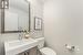 Powder room with upgraded mirrors and cabinetry