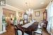 Dining area featuring a chandelier, wood-type flooring, ornamental molding, and plenty of natural light