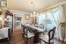 Dining area featuring an inviting chandelier, hardwood / wood-style floors, and ornamental molding