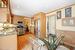 Kitchen featuring crown molding, appliances with stainless steel finishes, light brown cabinetry, sink, and light hardwood / wood-style floors