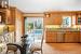 Kitchen featuring sink, light stone counters, crown molding, light wood-type flooring, and dishwasher