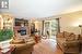 Living room featuring a textured ceiling, light hardwood / wood-style floors, and a fireplace