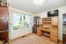 Office space featuring a textured ceiling, light hardwood / wood-style flooring, and ornamental molding