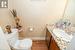 Bathroom featuring vanity, toilet, and wood-type flooring