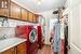 Laundry room with cabinets, light hardwood / wood-style floors, washing machine and dryer, and sink