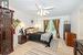 Bedroom with light colored carpet and ceiling fan