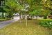 Obstructed view of property featuring a garage and a front lawn