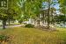 Obstructed view of property featuring a garage and a front lawn