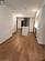 Kitchen featuring hardwood / wood-style flooring, stainless steel fridge, and white cabinets